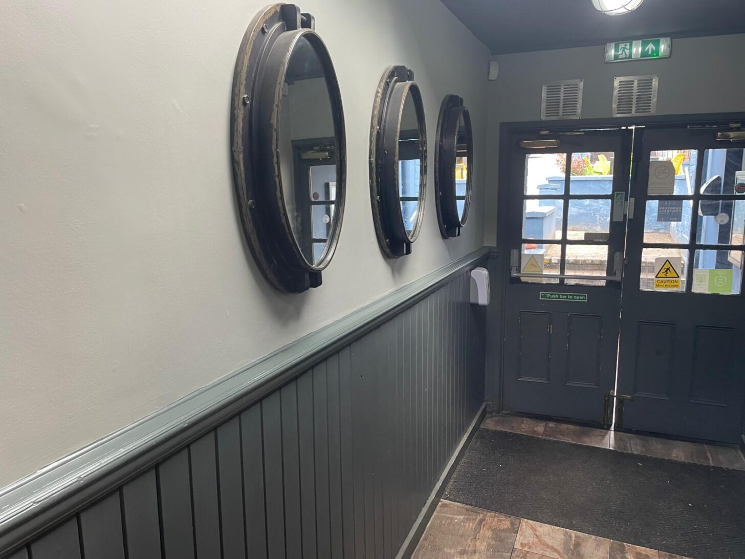 Pub interior with dark panelling and feature mirrors